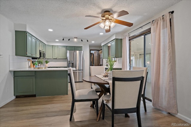 2130 Squires St, Longmont, CO 80501 - dining room with light wood finished floors, ceiling fan, a textured ceiling, and recessed lighting