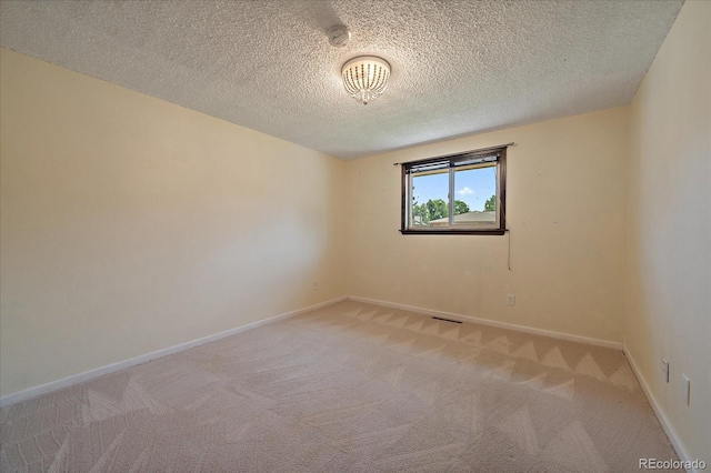 2130 Squires St, Longmont, CO 80501 - spare room with light colored carpet, a smoke detector, and a textured ceiling