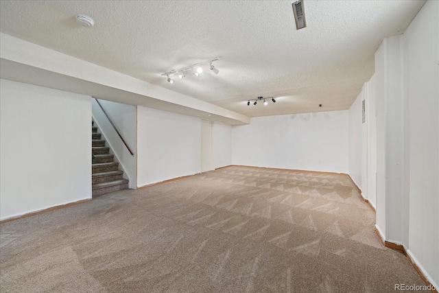 2130 Squires St, Longmont, CO 80501 - finished basement featuring carpet floors, track lighting, stairs, and a textured ceiling