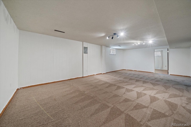 2130 Squires St, Longmont, CO 80501 - finished below grade area with carpet, rail lighting, and a textured ceiling
