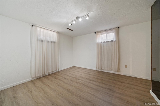 2130 Squires St, Longmont, CO 80501 - unfurnished room with wood finished floors and a textured ceiling
