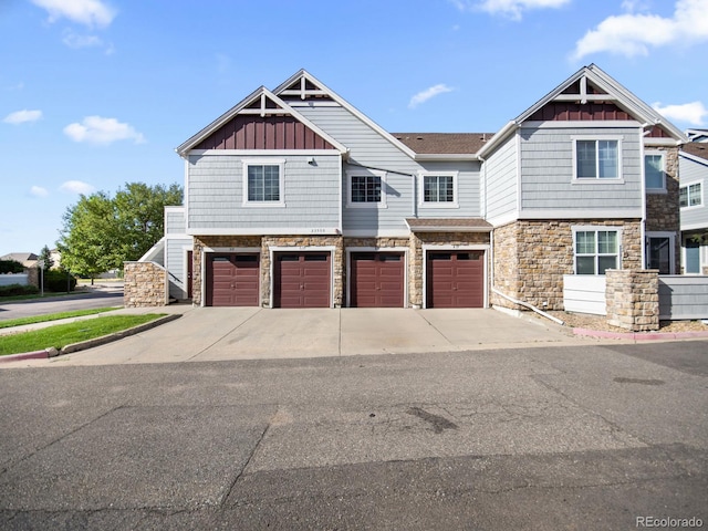 23500 E Alamo Pl Unit C, Aurora, CO 80016 - craftsman house featuring stone siding, a garage, board and batten siding, and driveway