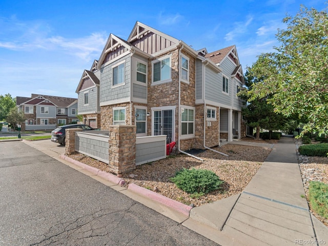 23500 E Alamo Pl Unit C, Aurora, CO 80016 - craftsman-style home featuring stone siding, board and batten siding, and a residential view
