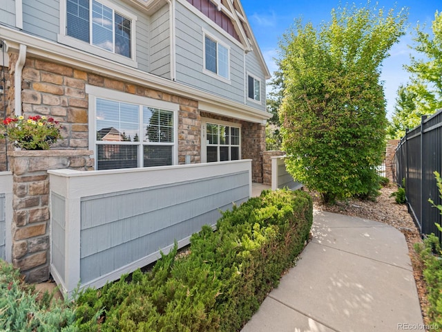 23500 E Alamo Pl Unit C, Aurora, CO 80016 - view of side of home featuring board and batten siding and stone siding