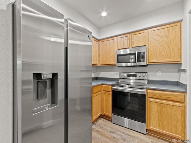 23500 E Alamo Pl Unit C, Aurora, CO 80016 - kitchen featuring appliances with stainless steel finishes, light wood-style flooring, light brown cabinetry, dark countertops, and recessed lighting