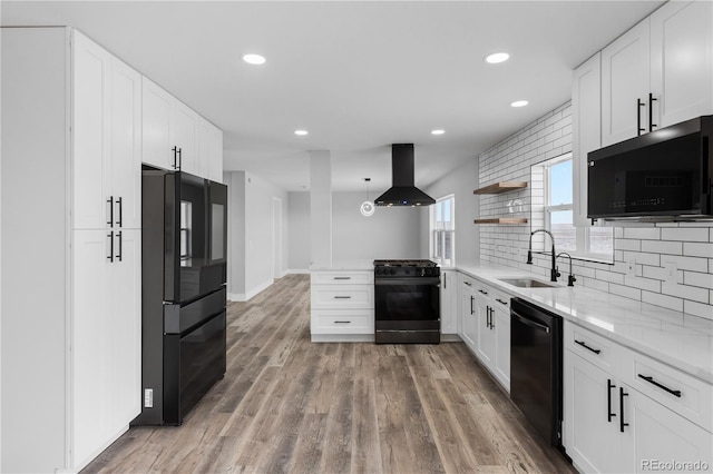 kitchen with sink, black appliances, exhaust hood, and white cabinets