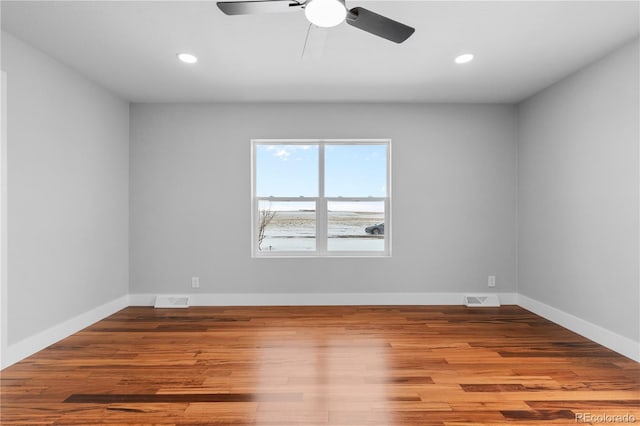 unfurnished room featuring ceiling fan and hardwood / wood-style floors