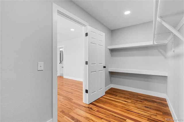 spacious closet featuring hardwood / wood-style flooring