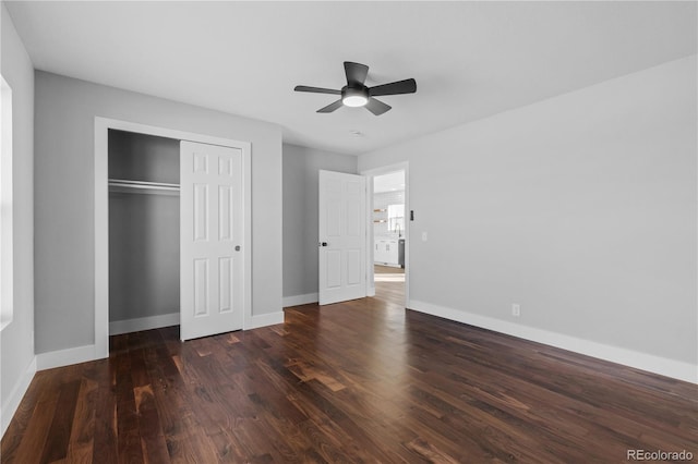 unfurnished bedroom with ceiling fan, dark hardwood / wood-style flooring, and a closet