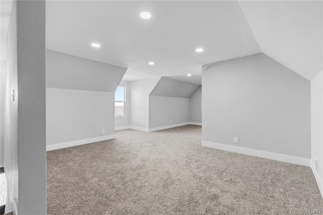 bonus room featuring lofted ceiling and carpet