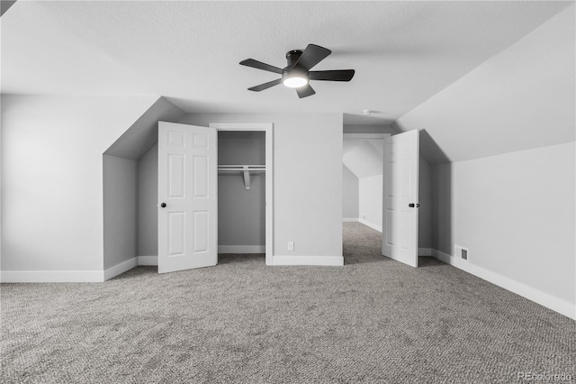 unfurnished bedroom with vaulted ceiling, carpet, and ceiling fan