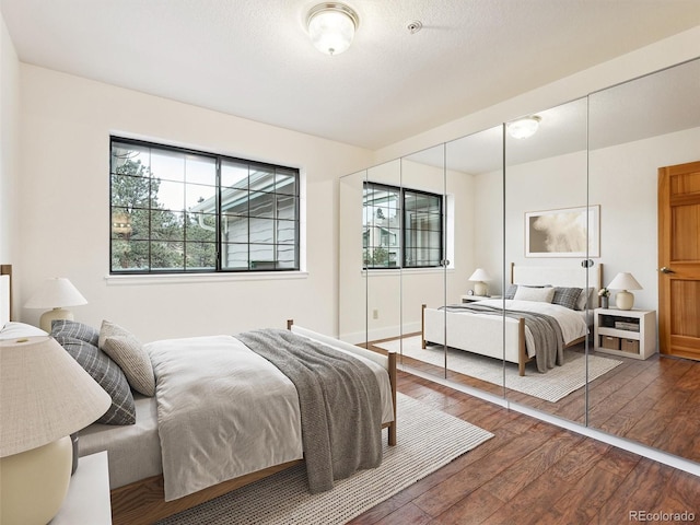 bedroom featuring hardwood / wood-style flooring and a closet