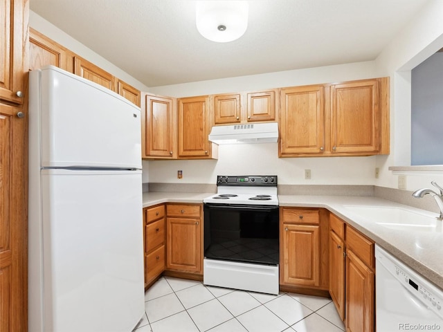 kitchen featuring white appliances, sink, and light tile patterned floors