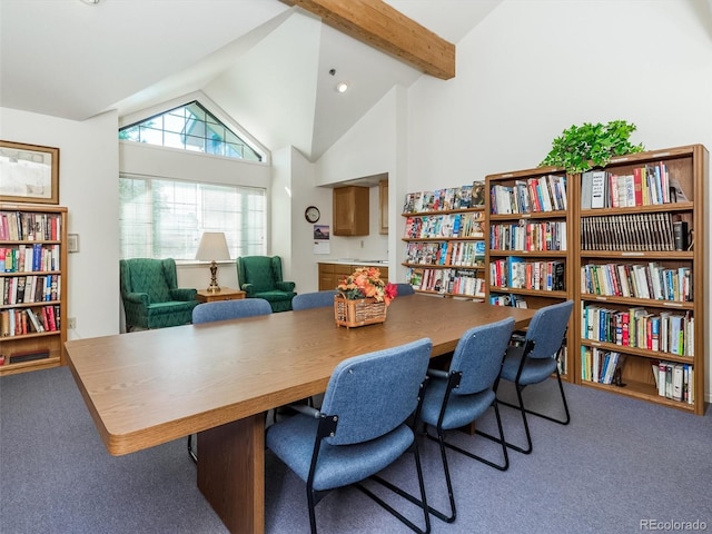 carpeted office space with beamed ceiling and high vaulted ceiling