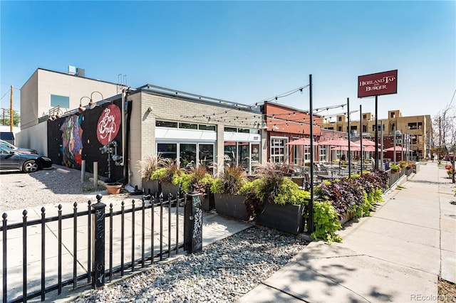 view of building exterior with fence