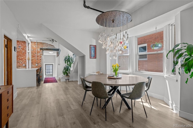 dining space with wood finished floors and baseboards
