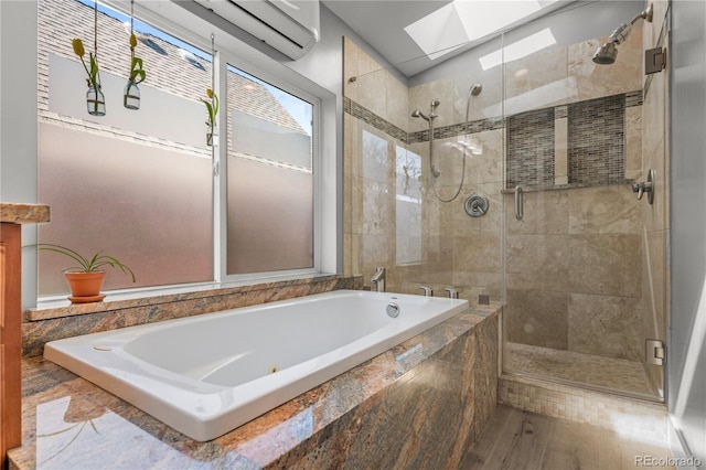 full bathroom featuring a skylight, a shower stall, a garden tub, and wood finished floors