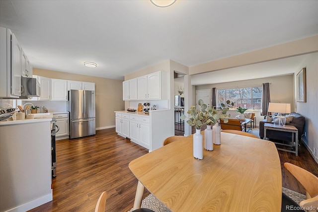 dining space featuring dark wood-type flooring