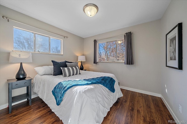 bedroom with dark hardwood / wood-style flooring