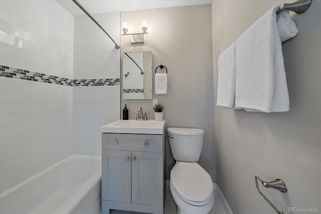 full bathroom with vanity, toilet, and tiled shower / bath