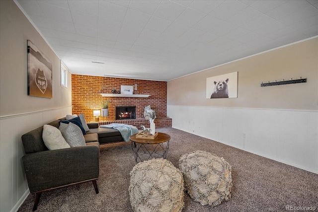 carpeted living room with a brick fireplace and ornamental molding