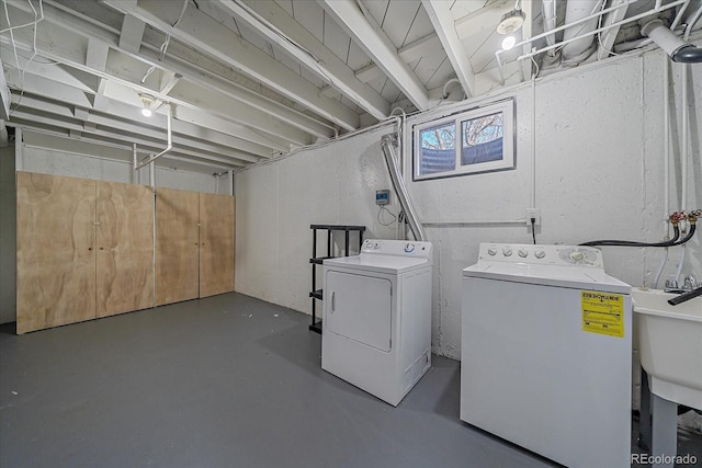 clothes washing area with washing machine and clothes dryer