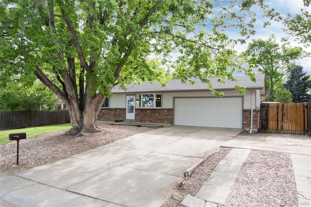 7695 S Harlan St, Littleton, CO 80128 - ranch-style home with brick siding, concrete driveway, and an attached garage