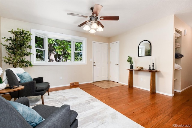 7695 S Harlan St, Littleton, CO 80128 - living area featuring wood finished floors, baseboards, and a ceiling fan