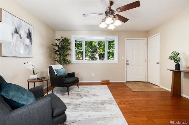 7695 S Harlan St, Littleton, CO 80128 - sitting room with wood finished floors, ceiling fan, and baseboards