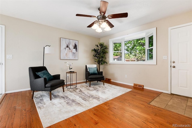 7695 S Harlan St, Littleton, CO 80128 - sitting room featuring light wood-style floors, baseboards, and ceiling fan