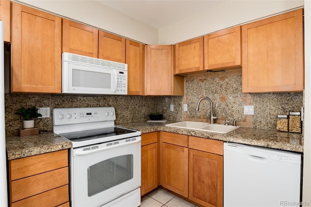7695 S Harlan St, Littleton, CO 80128 - kitchen with white appliances, a sink, decorative backsplash, and light tile patterned floors