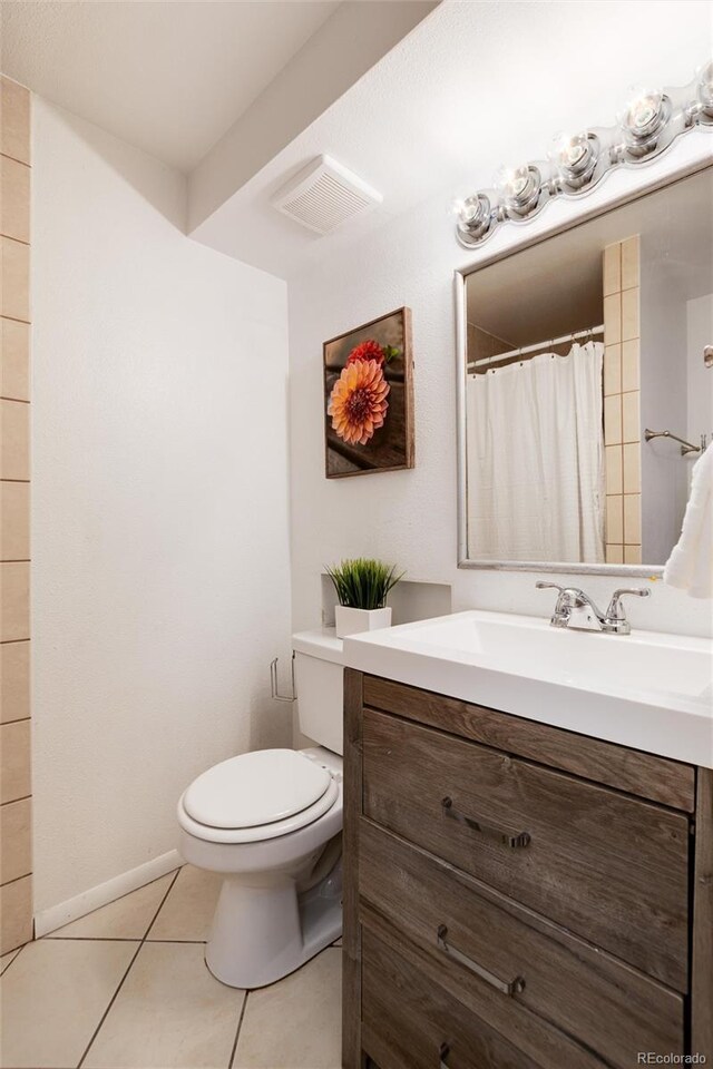 7695 S Harlan St, Littleton, CO 80128 - full bathroom with vanity, toilet, and tile patterned flooring