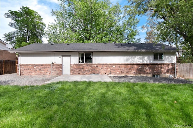 7695 S Harlan St, Littleton, CO 80128 - back of property featuring brick siding and a patio area