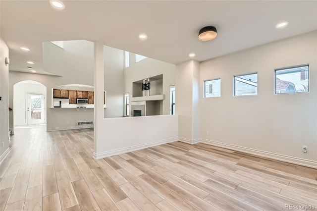 unfurnished living room with visible vents, light wood-style flooring, and recessed lighting