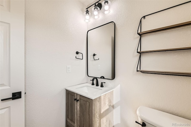 half bath featuring toilet and vanity