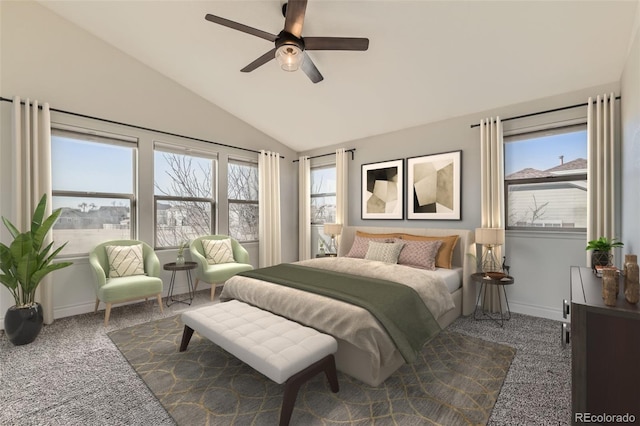 carpeted bedroom featuring vaulted ceiling, multiple windows, a ceiling fan, and baseboards