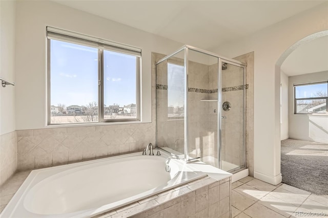 full bathroom featuring a stall shower, a garden tub, and tile patterned floors