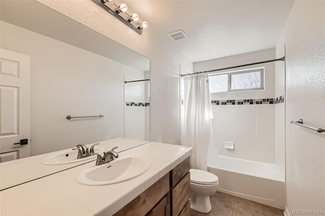 full bathroom featuring visible vents, shower / bathtub combination with curtain, toilet, vanity, and tile patterned floors