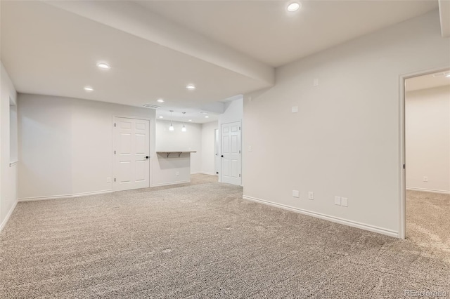 interior space with light carpet, visible vents, baseboards, and recessed lighting