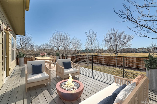 deck featuring outdoor dining space and an outdoor living space with a fire pit