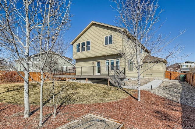 rear view of house featuring a gate, a fenced backyard, and a wooden deck