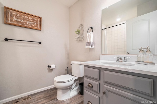 bathroom featuring toilet, wood-type flooring, vanity, and a shower with curtain