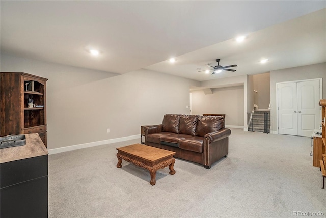 carpeted living room featuring ceiling fan