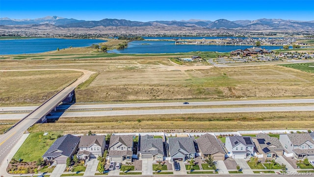 drone / aerial view with a water and mountain view