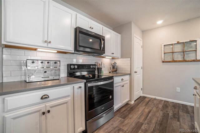 kitchen with dark wood-type flooring, decorative backsplash, stainless steel range with electric cooktop, and white cabinets