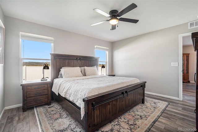 bedroom featuring ceiling fan and dark hardwood / wood-style flooring