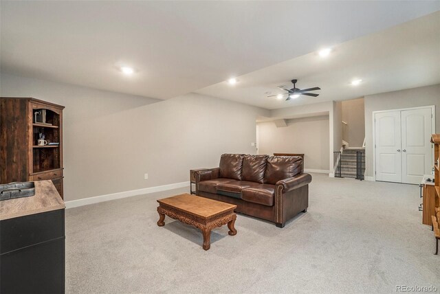 carpeted living room with ceiling fan