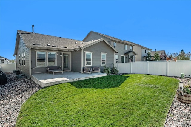 back of property with cooling unit, a yard, and a patio