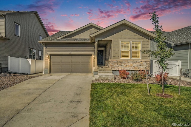 view of front of home with a garage and a yard