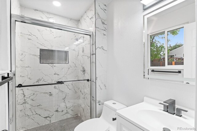 4672 S Lewiston Way, Aurora, CO 80015 - bathroom with toilet, vanity, and a marble finish shower